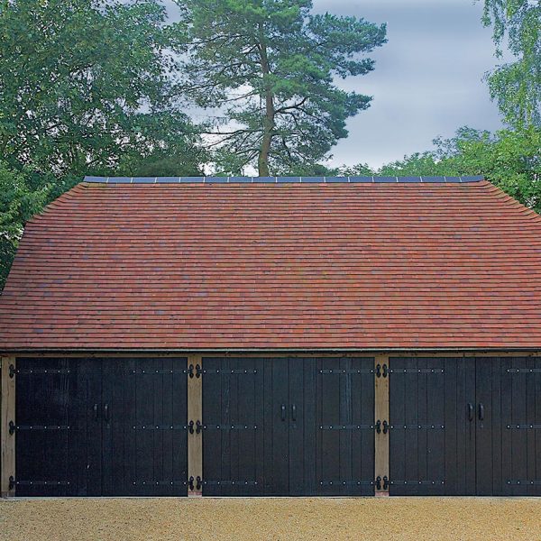 This oak frame has barn hip end roof, finished in a clay tile with a contrasting clay ridge.